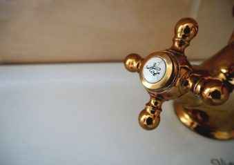 closeup of hot water bronze tap in the bathroom.